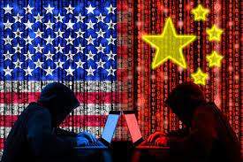 Two people using computers with an American and CHinese flag as a background.