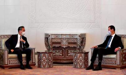 President Bashar al-Assad (right) meets visiting Chinese foreign minister Wang Yi in Damascus. Photograph: Xinhua/REX/Shutterstock