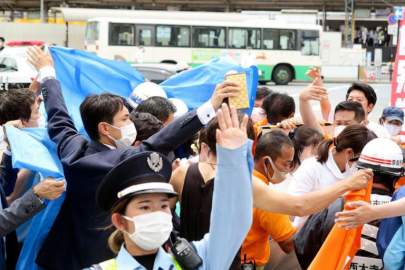 © Kyodo News via AP People react after gunshots in Nara, western Japan Friday, July 8, 2022. Japan’s former Prime Minister Shinzo Abe was in heart failure after apparently being shot during a campaign speech Friday in western Japan, NHK public television said Friday.