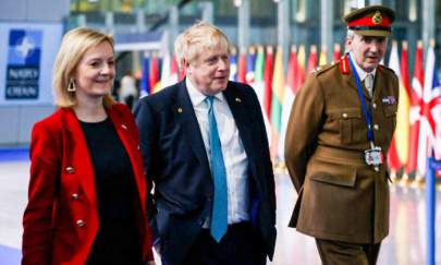 Britain's Prime Minister Boris Johnson (C), Britain's Foreign Secretary Liz Truss (L), and Britain's military representative to NATO Ben Bathurst (R) leave NATO Headquarters following a summit in Brussels on March 24, 2022. (Henry Nicholls /Pool/AFP via Getty Images)