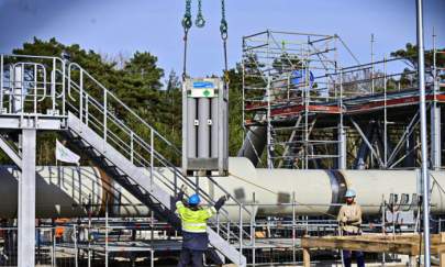 Men work at the construction site of the Nord Stream 2 gas pipeline in Lubmin, northeastern Germany, on March 26, 2019. (Tobias Schwarz/AFP via Getty Images)