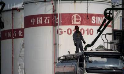 A man works in a filling station of Sinopec, China Petroleum and Chemical Corporation, in Shanghai on March 22, 2018. (Johannes Eisele/AFP via Getty Images)