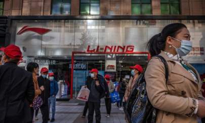 Tourists and shoppers walk by a Li-Ning store, a Chinese sportswear brand, at a shopping district in Beijing on April 16, 2021. (Kevin Frayer/Getty Images)