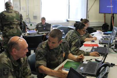 French soldiers comb through information streaming in from both a virtual battlefield and real operational activities at its mission command headquarters at the U.S. Army-hosted Joint Warfighting Assessment at Grafenwoehr, Germany. The Pentagon wants to tap U.S. industry to help allies and partners better secure systems from cyber attack. (Jen Judson/Staff)