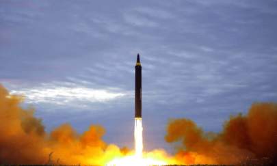 North Korea's intermediate-range strategic ballistic rocket Hwasong-12 lifting off from the launching pad at an undisclosed location near Pyongyang on Aug. 29, 2017. (STR/AFP via Getty Images)