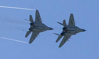 Two polish MiG-29s fly over the air base in Malbork, Poland, on April 29, 2014. (Joel Saget/AFP via Getty Images)