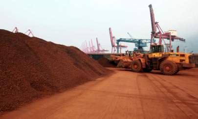 A loader shifts soil containing rare earth minerals to be loaded at a port in Lianyungang, in China's Jiangsu Province, for export to Japan. China controls the world’s supply of rare earth minerals and the United States is seeking partnerships with allies to reduce its dependence on China. (STR/AFP via Getty Images)