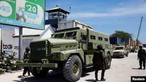 FILE - African Union peacekeepers stand next to an armored personnel carrier as they provide security for members of the Lower House of Parliament who are meeting to elect a speaker, at the Aden Adde International Airport in Mogadishu, Somalia, April 27, 2022.