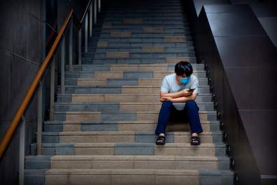 A man checks his phone in Beijing. The Chinese government is making an effort to clean up how the country’s fast-growing tech sector operates. PHOTO: MARK SCHIEFELBEIN/ASSOCIATED PRESS