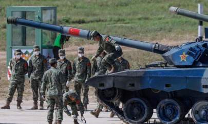 Chinese soldiers operate with their Type 96A tank during the Tank Biathlon competition at the International Army Games 2022 in Alabino, outside Moscow, Russia, on Aug. 16, 2022. (Maxim Shemetov/Reuters)