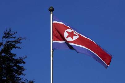 FILE PHOTO - A North Korean flag flies on a mast at the Permanent Mission of North Korea in Geneva October 2, 2014. REUTERS/Denis Balibouse/File Picture