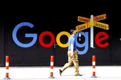 FILE PHOTO: A man walks past a logo of Alphabet Inc's Google in front of at an office building in Zurich, Switzerland July 1, 2020. REUTERS/Arnd Wiegmann