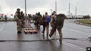 AP -  In this photo taken from video released by the Russian Defense Ministry on May 19, 2022, Ukrainian servicemen, right, leave the besieged Azovstal steel plant in Mariupol, Ukraine.