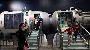 Reuters - FILE - Visitors walk near a model of a space laboratory at an exhibition featuring the development of China's space exploration, on the country's Space Day at the China Science and Technology Museum in Beijing, April 24, 2021.