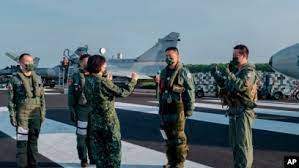 AP - FILE - In this Sept. 15, 2021, file photo released by the Taiwan Presidential Office, Taiwanese President Tsai Ing-wen, center, speaks with military personnel near aircraft parked on a highway in Jiadong, Taiwan.