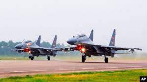 AP - FILE - Two Chinese SU-30 fighter jets take off from an unspecified location to fly a patrol over the South China Sea, in this undated photo released by China's Xinhua News Agency.