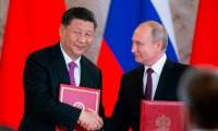 Russian President Vladimir Putin and his Chinese counterpart Xi Jinping exchange documents during a signing ceremony following their talks at the Kremlin in Moscow on June 5, 2019. (Alexander Zemlianichenko/AFP/Getty Images)